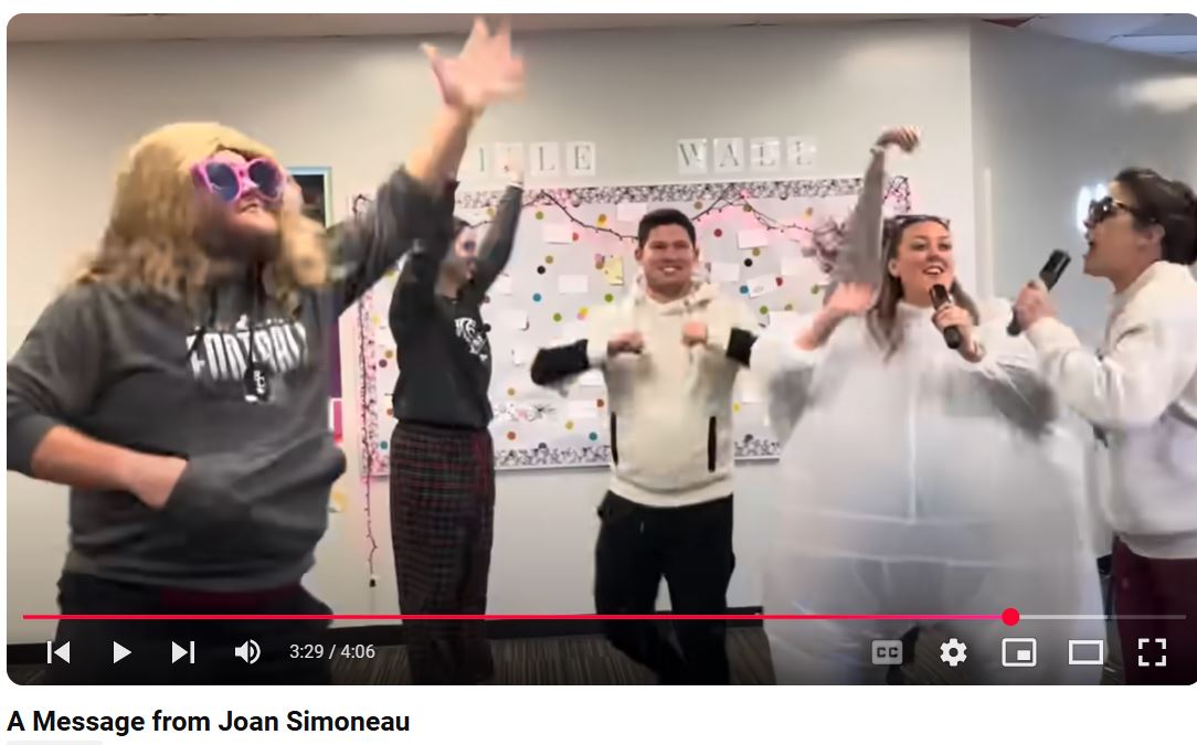 Screen Capture of RCHS Choirs YouTube of "Snow Day On" Lyrics by Joan Simoneau and performed by Rock Creek faculty and staff. 