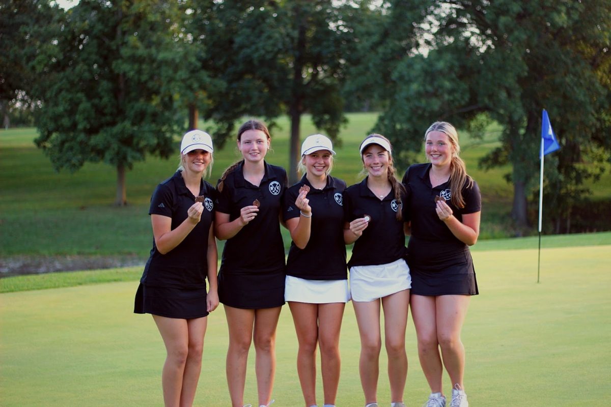 Posing for a team picture, the Rock Creek Girl’s Golf team finished an outstanding 18-hole tournament in Holton, KS, and they continued to swing their way to success.