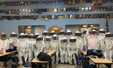Buzzing with excitement. The Ag class suits up for the first time to check on their hives located on the back side of the Ag building on the Rock Creek campus. Photo provided by David Holliday