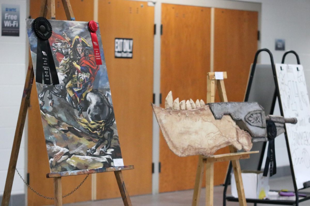 Award-winning artwork from Rock Creek High School students is displayed in the high school lobby, showcasing pieces recognized at Highland Art Day.